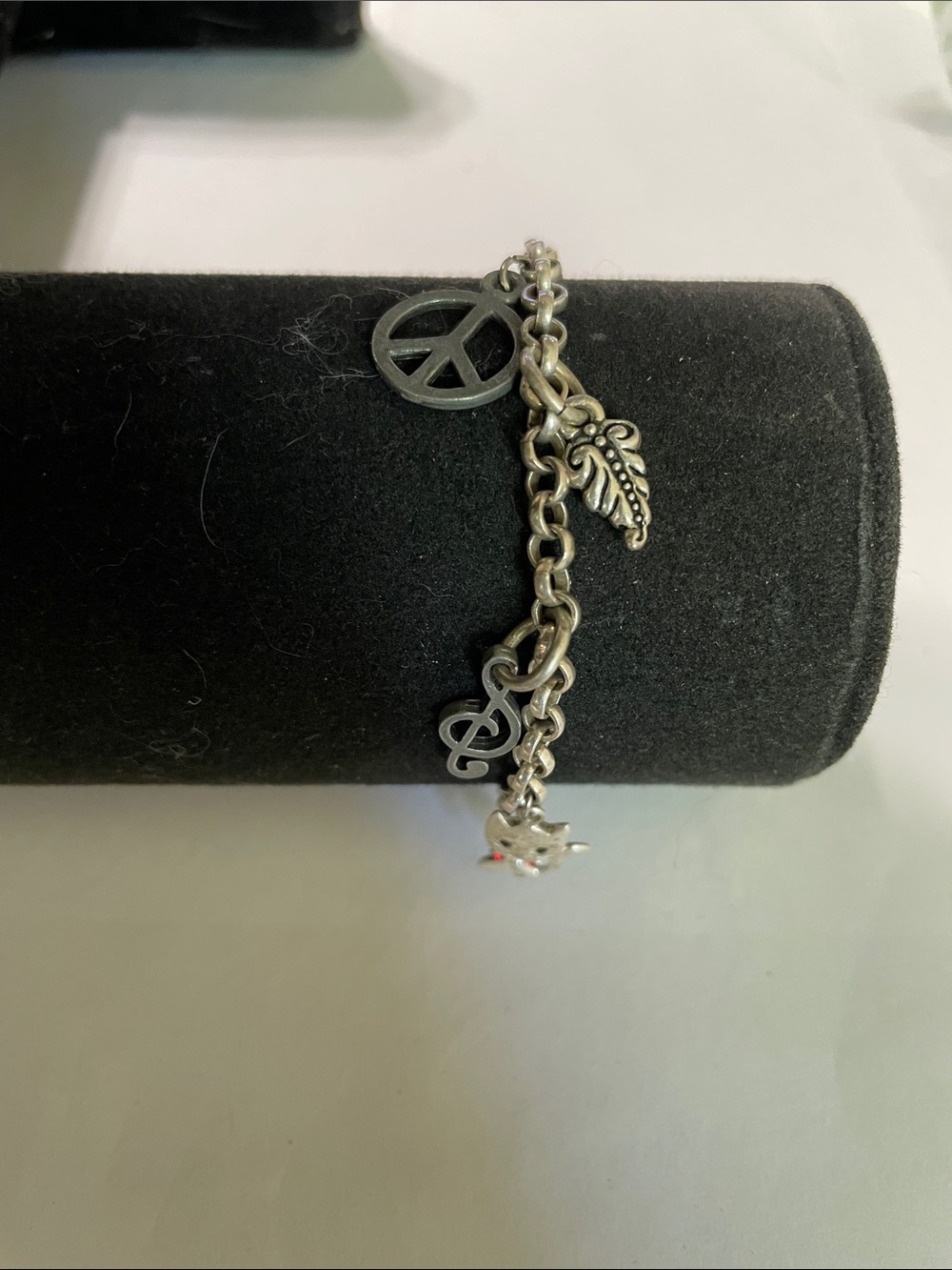 Silver Charm Bracelet with Peace Sign and Leaf Charms 6/27/6.    6.25”